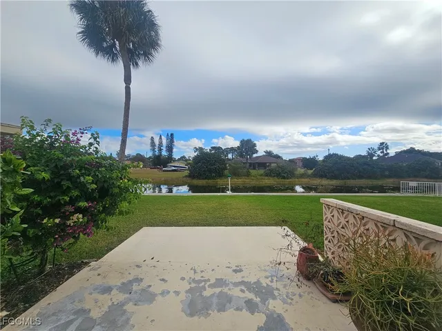 an aerial view of a house with a garden and lake view