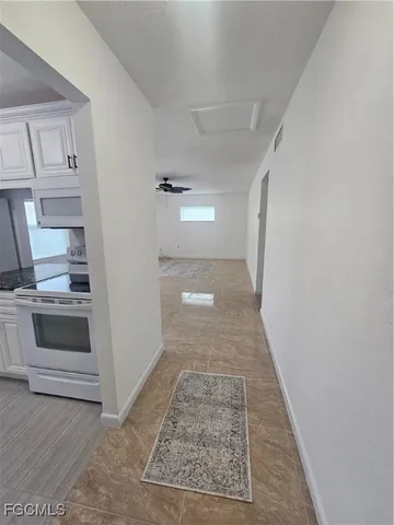 a large kitchen with stainless steel appliances granite countertop a stove and a sink