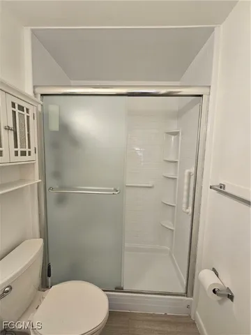 a view of an empty room with a chandelier fan