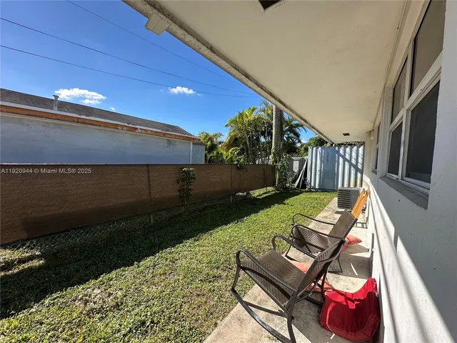 a view of backyard with seating space