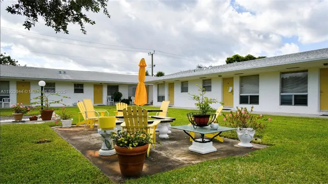 a front view of a house with porch and garden