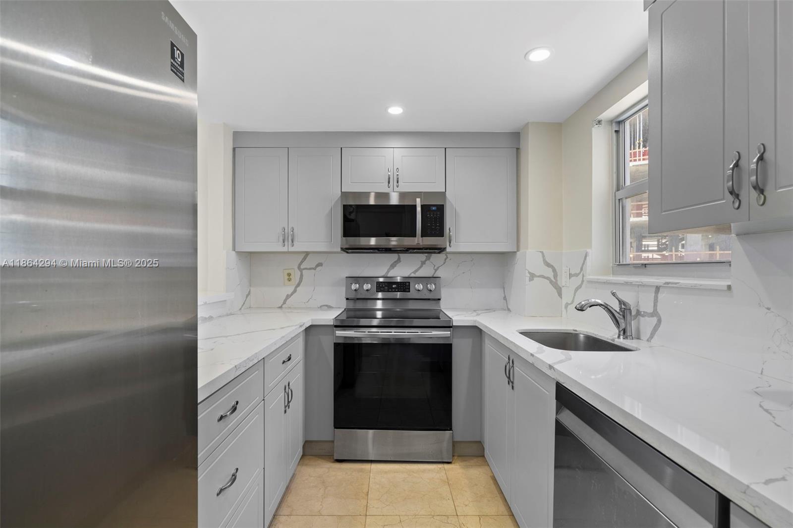3301 Northeast 5th Avenue, Unit 1018 Miami, FL 33137 - Photo 16 of 24 a kitchen with stainless steel appliances granite countertop a sink and a stove