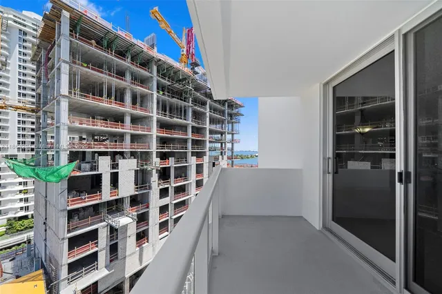 a view of a kitchen with wooden floor and a kitchen