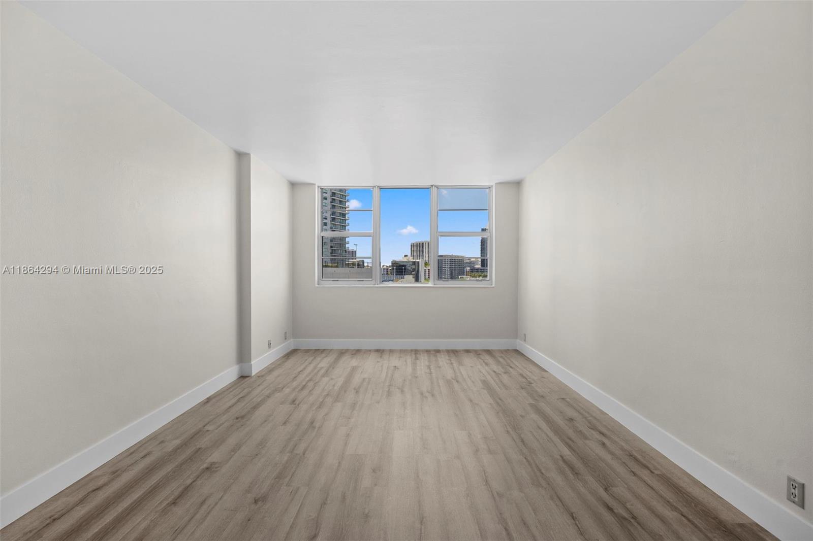 3301 Northeast 5th Avenue, Unit 1018 Miami, FL 33137 - Photo 23 of 24 a view of a room with wooden floor and window