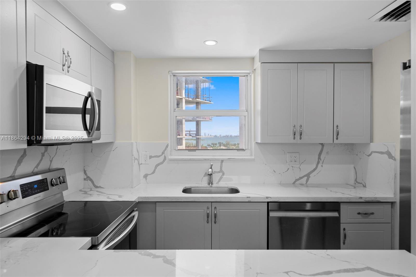 3301 Northeast 5th Avenue, Unit 1018 Miami, FL 33137 - Photo 3 of 24 a kitchen that has a sink and a stove