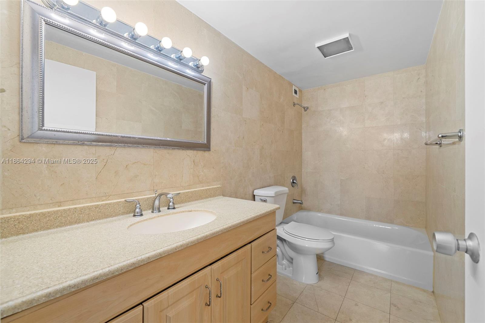 3301 Northeast 5th Avenue, Unit 1018 Miami, FL 33137 - Photo 4 of 24 a bathroom with a sink a toilet and a mirror