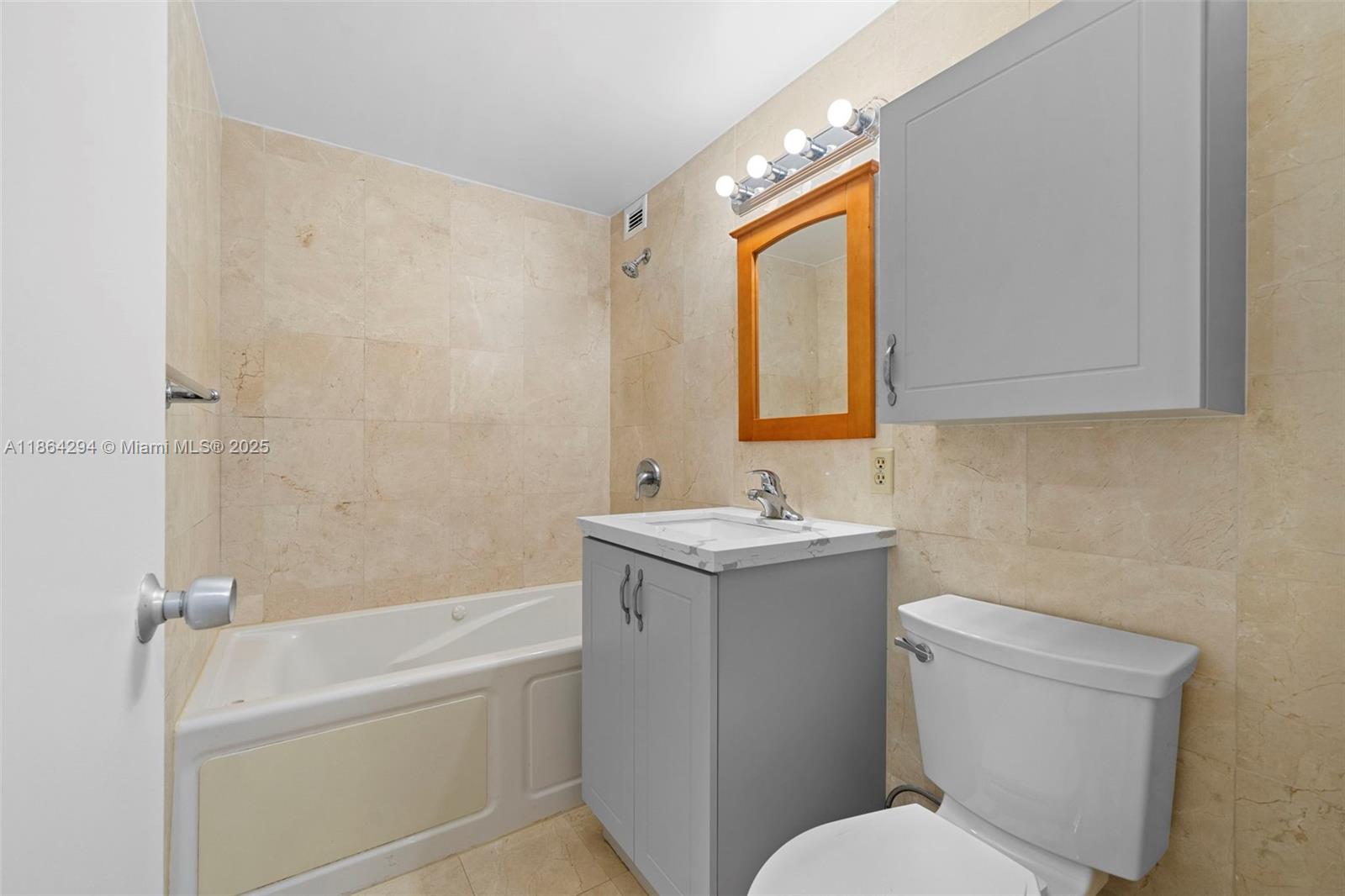 3301 Northeast 5th Avenue, Unit 1018 Miami, FL 33137 - Photo 7 of 24 a bathroom with a sink a toilet and shower