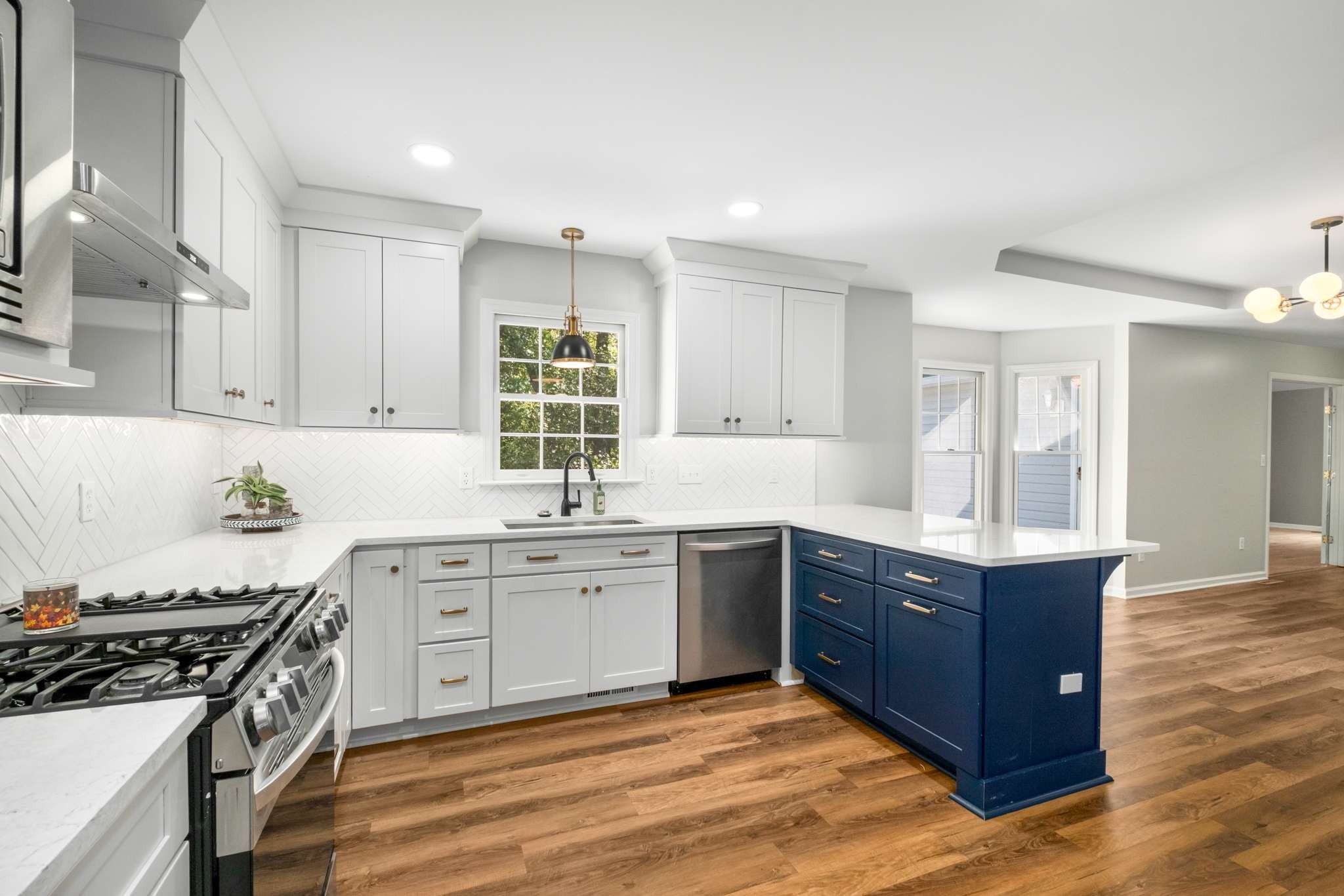 a kitchen with stainless steel appliances granite countertop a stove a sink dishwasher and a refrigerator