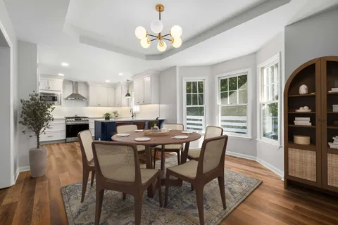 a view of a dining room with furniture window and wooden floor