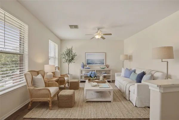 a living room with furniture and a lamp