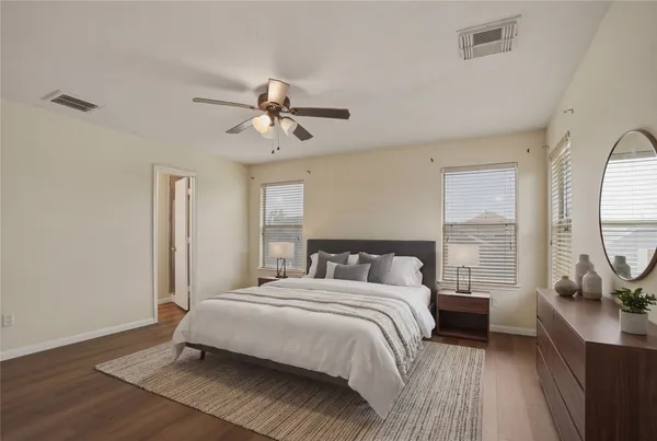 a bedroom with a bed a chandelier and a window