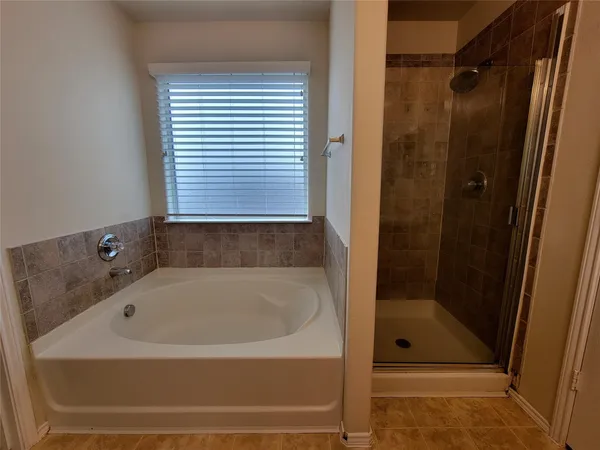 a bathroom with a bath tub and shower