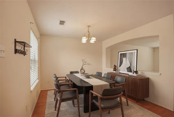 a dining room with furniture and window