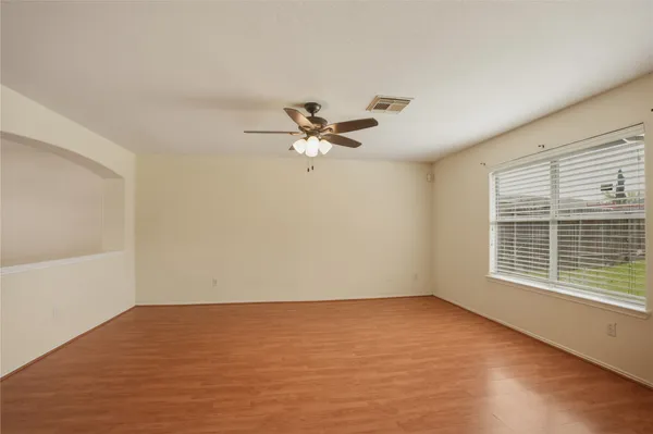 a view of a livingroom with a ceiling fan and window