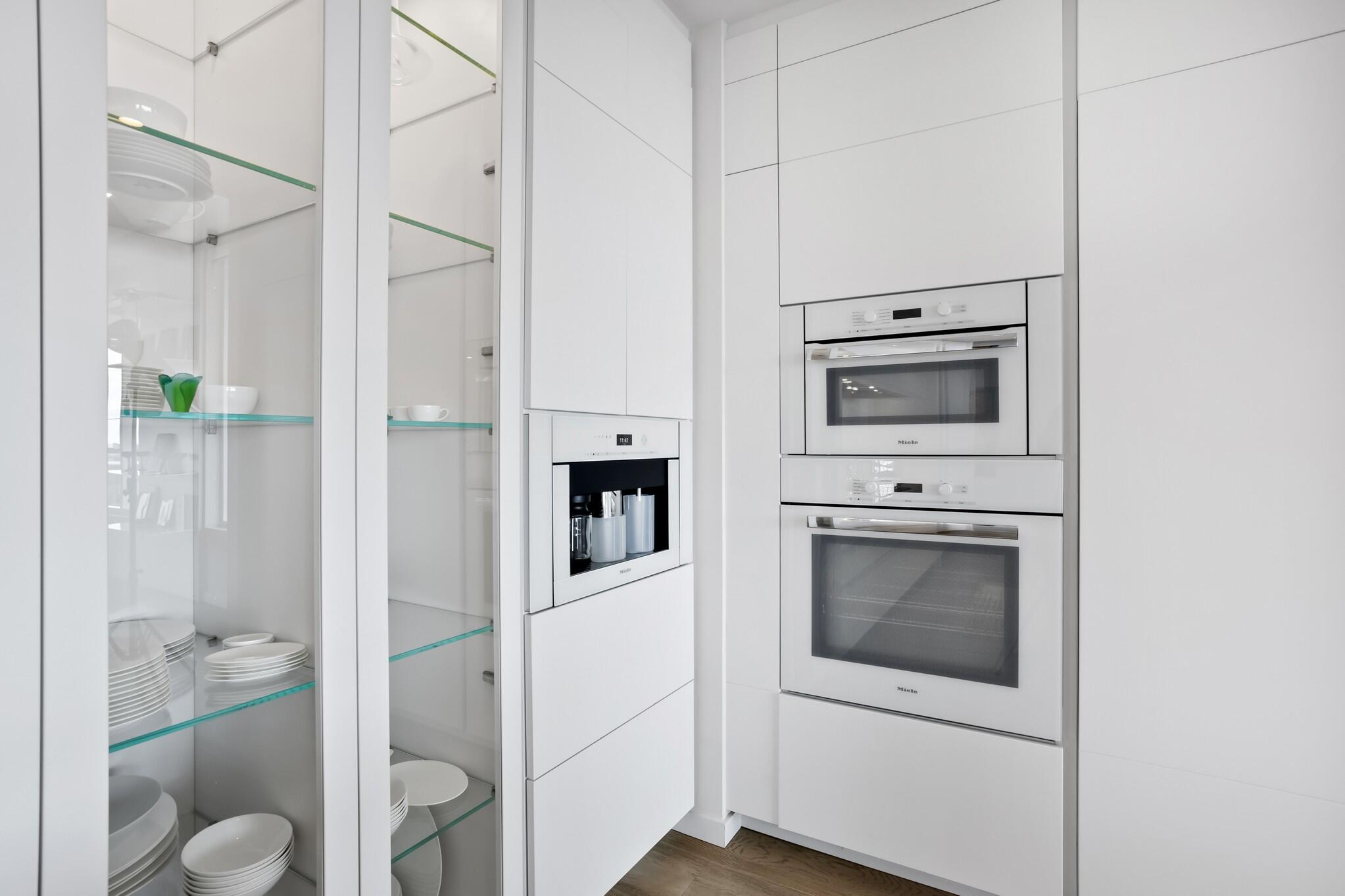 200 Southeast Mizner Boulevard, Unit 717 Boca Raton, FL 33432 - Photo 13 of 66 a view of a hallway with toilet and a refrigerator