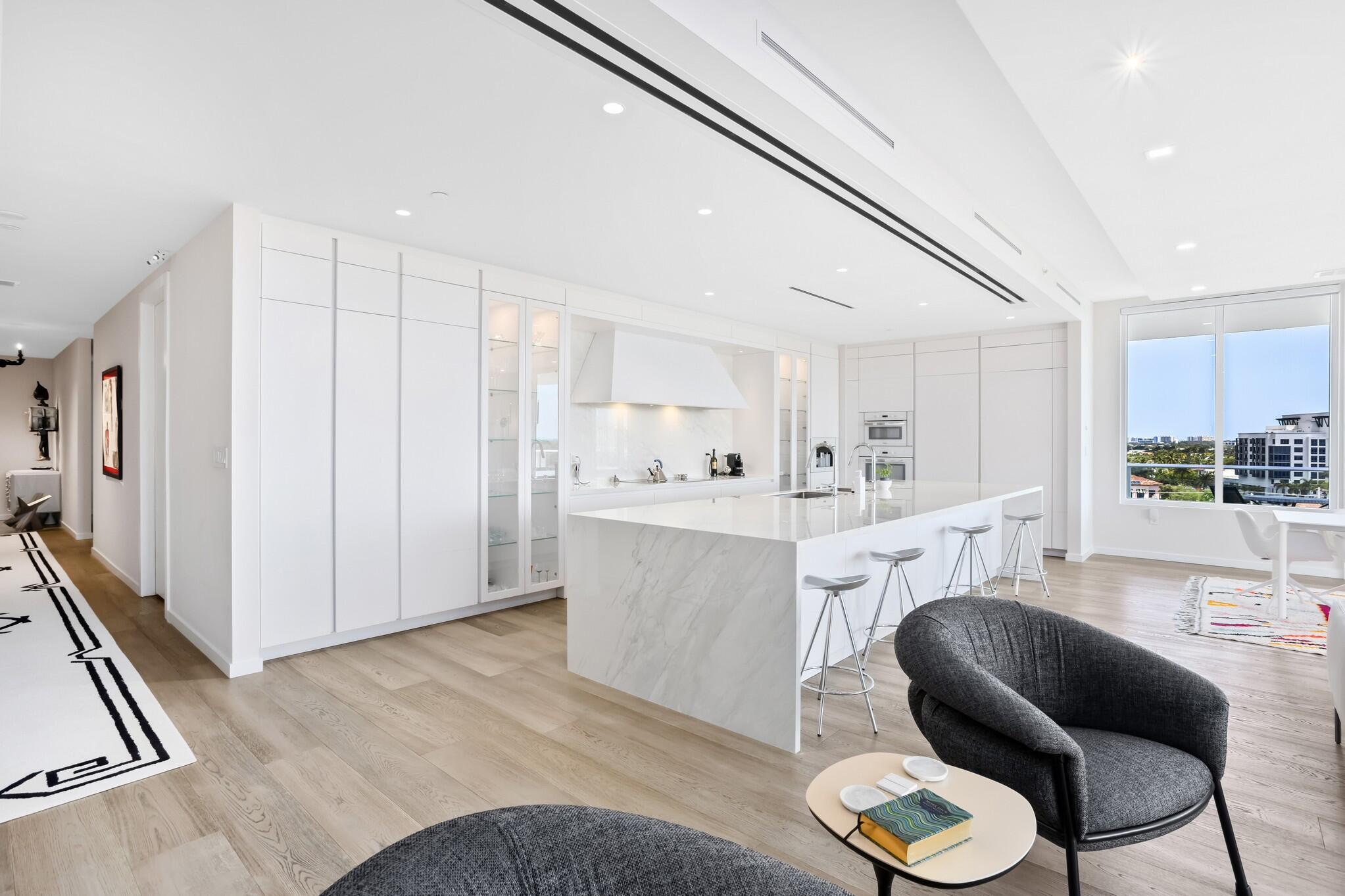 200 Southeast Mizner Boulevard, Unit 717 Boca Raton, FL 33432 - Photo 14 of 66 a living room with furniture and a wooden floor
