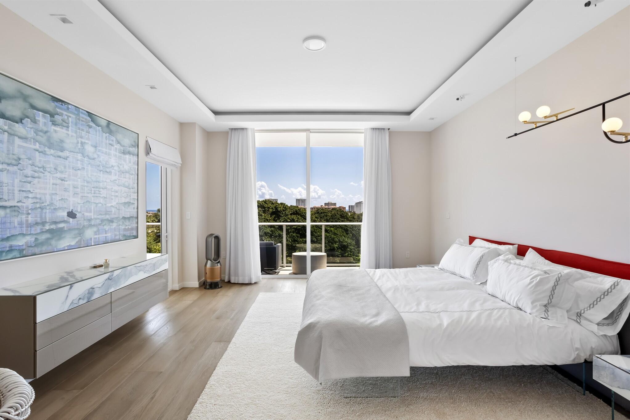 200 Southeast Mizner Boulevard, Unit 717 Boca Raton, FL 33432 - Photo 20 of 66 a bedroom with a large bed and a large window