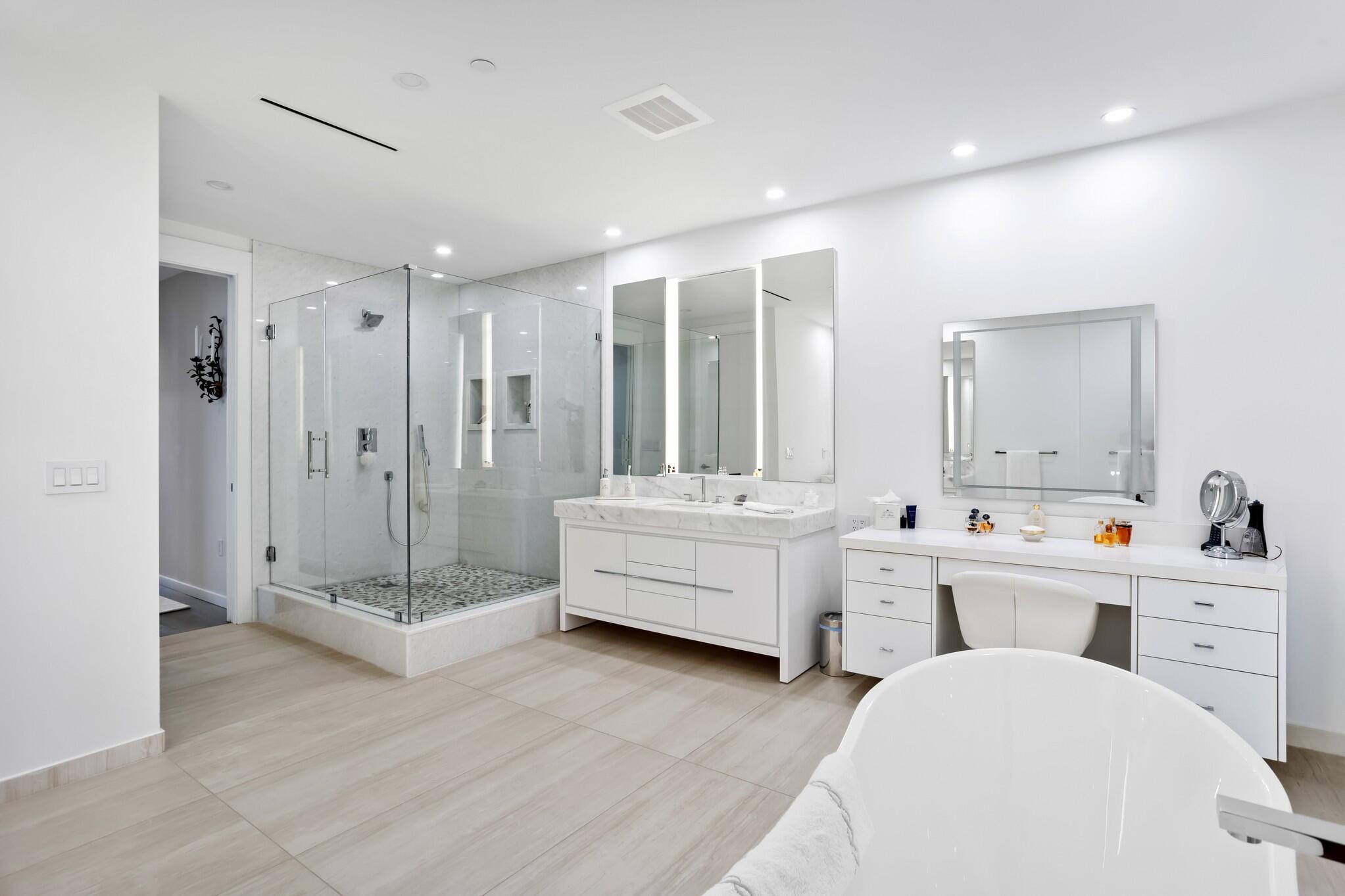 200 Southeast Mizner Boulevard, Unit 717 Boca Raton, FL 33432 - Photo 23 of 66 a bathroom with a double vanity sink mirror and bathtub