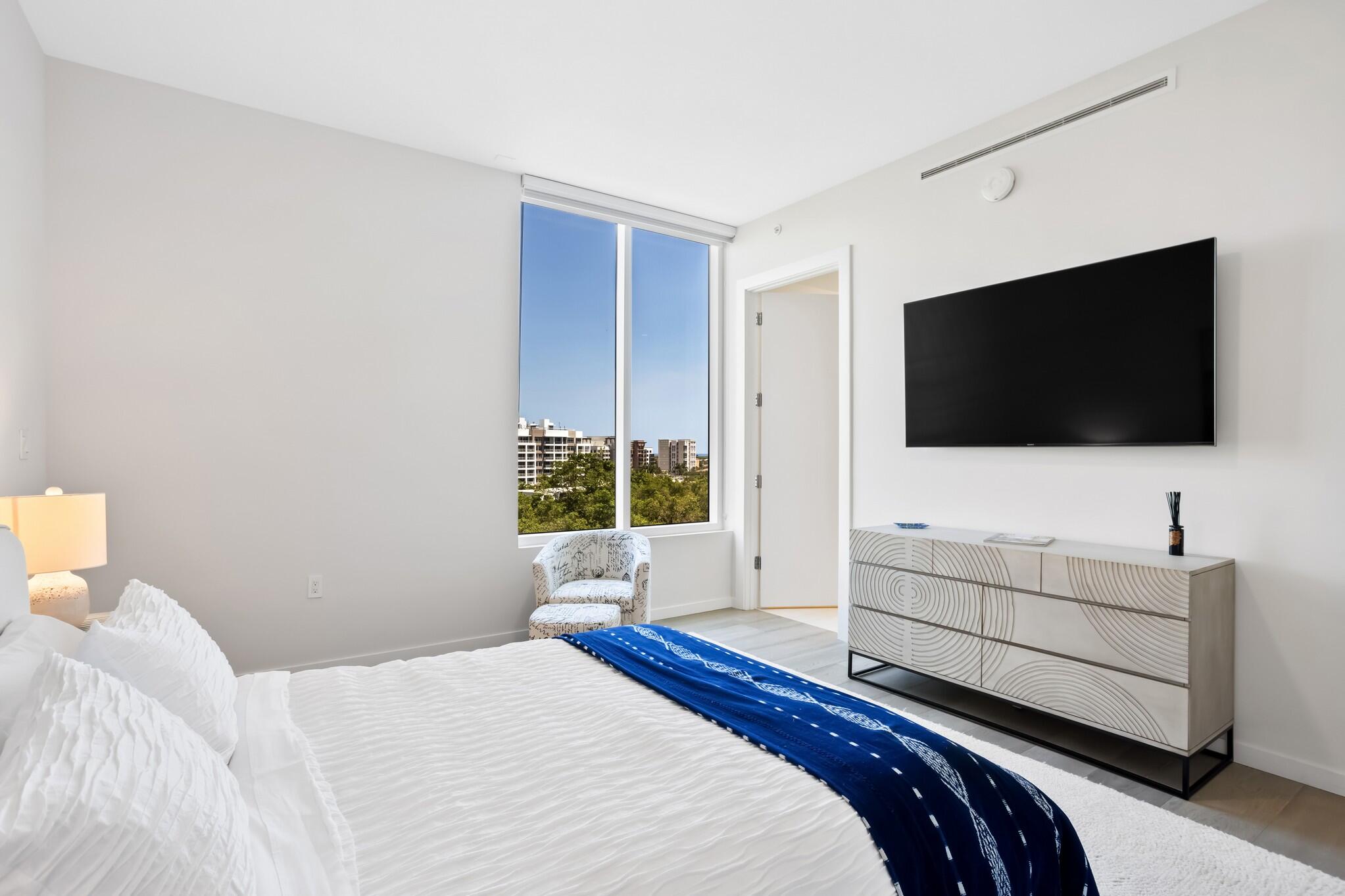 200 Southeast Mizner Boulevard, Unit 717 Boca Raton, FL 33432 - Photo 34 of 66 a bedroom with a bed and a flat screen tv