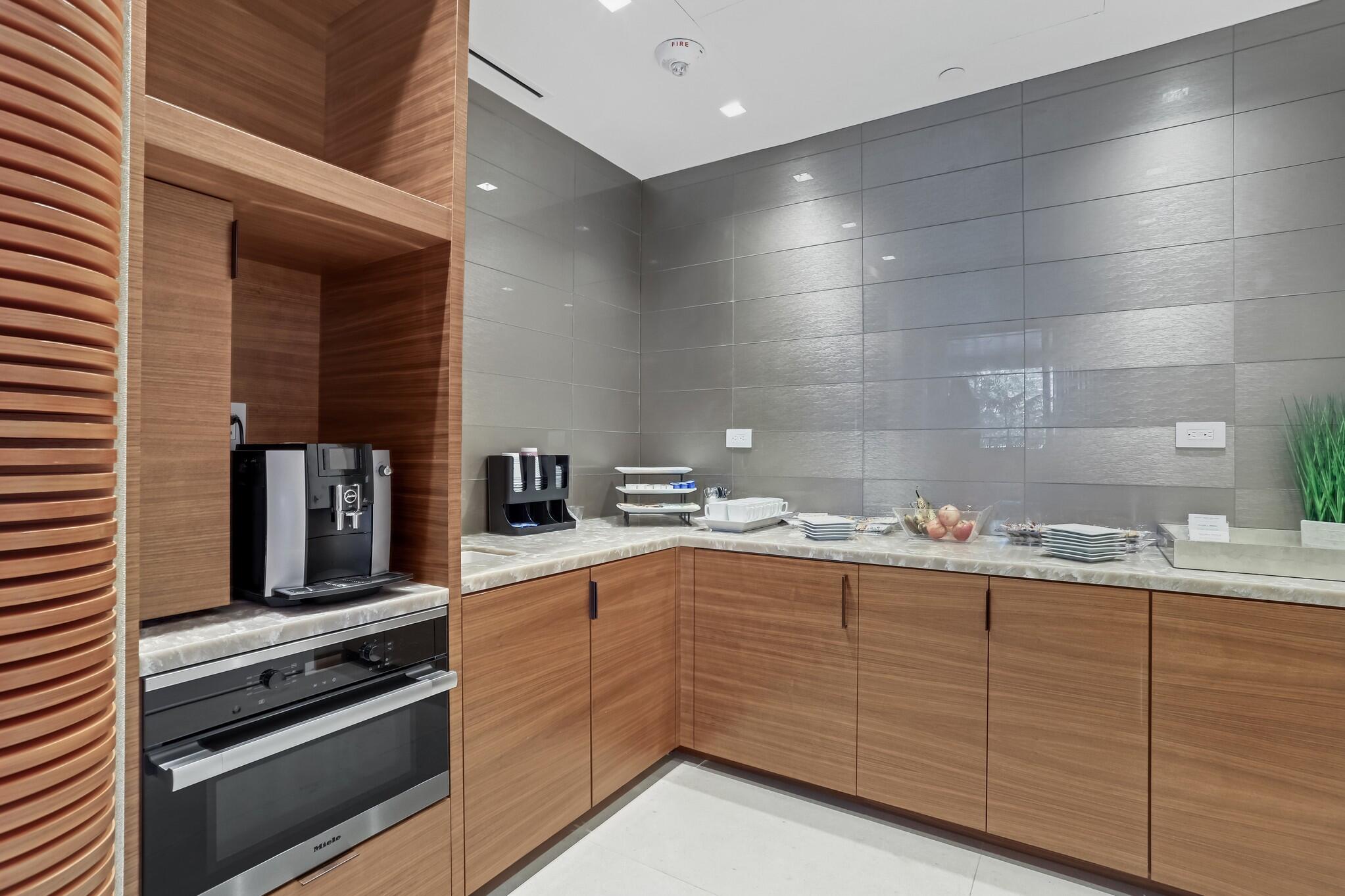 200 Southeast Mizner Boulevard, Unit 717 Boca Raton, FL 33432 - Photo 60 of 66 a kitchen with sink and cabinets