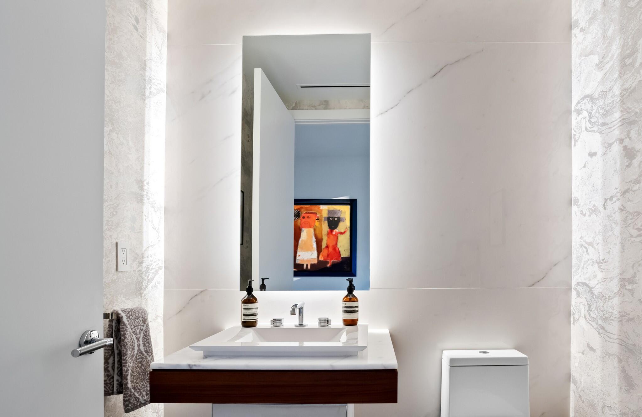 200 Southeast Mizner Boulevard, Unit 717 Boca Raton, FL 33432 - Photo 65 of 66 a bathroom with a sink and a mirror