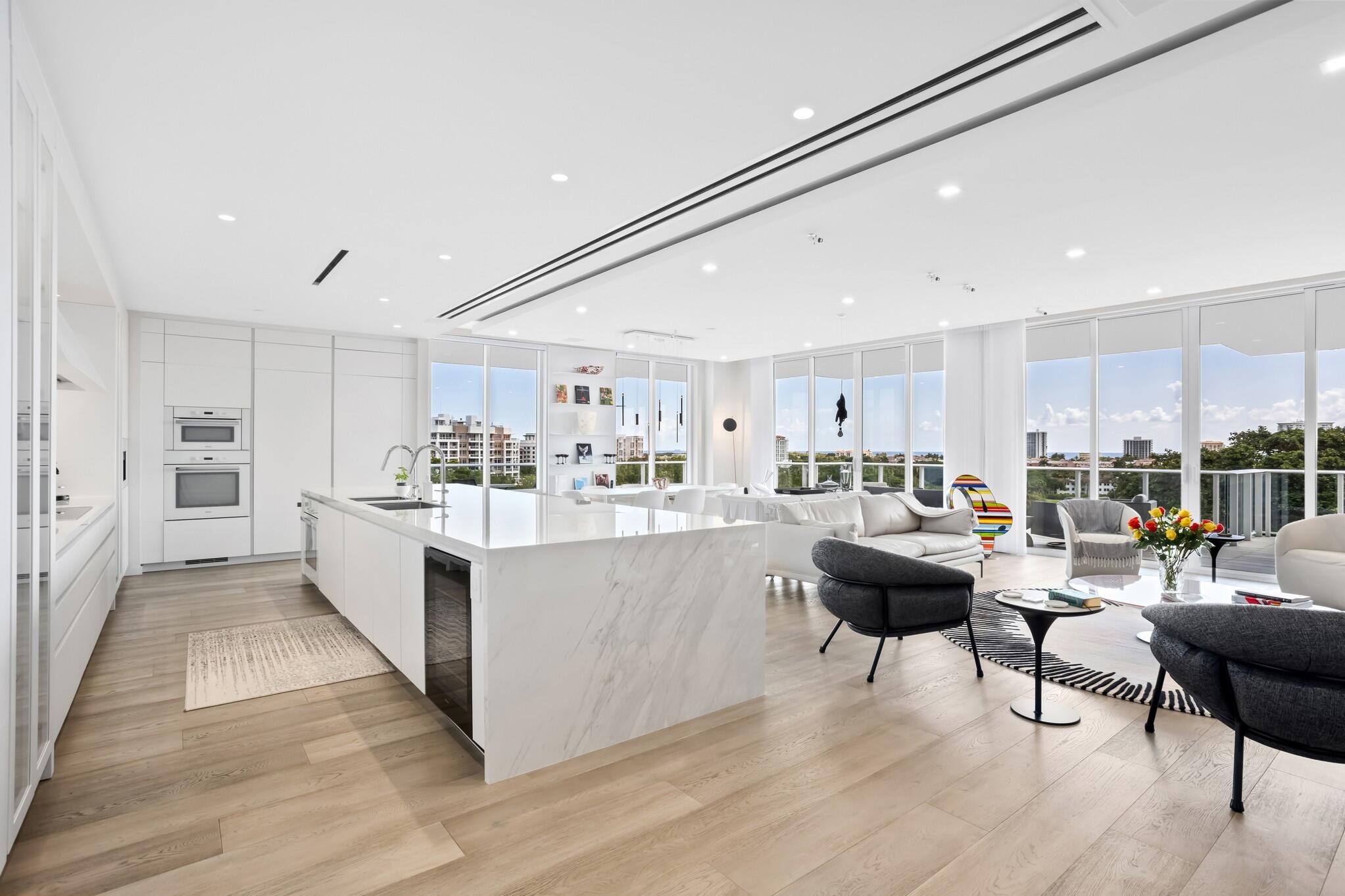 200 Southeast Mizner Boulevard, Unit 717 Boca Raton, FL 33432 - Photo 8 of 66 a living room with stainless steel appliances kitchen island granite countertop furniture a rug kitchen view and a refrigerator