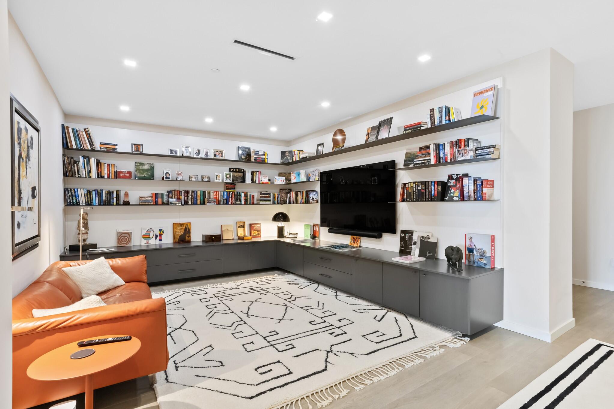 200 Southeast Mizner Boulevard, Unit 717 Boca Raton, FL 33432 - Photo 9 of 66 a room with furniture and a flat screen tv