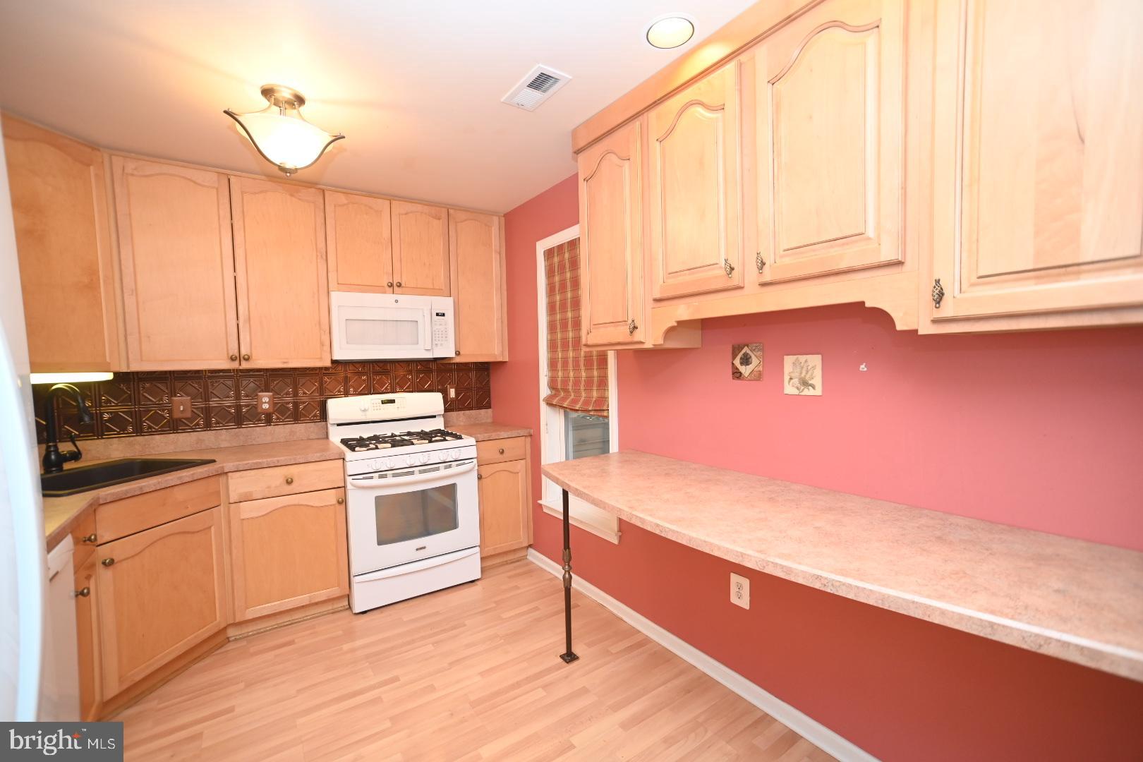 29 Ashley Drive Warminster, PA 18974 - Photo 7 of 44 a kitchen with a stove a sink and white cabinets