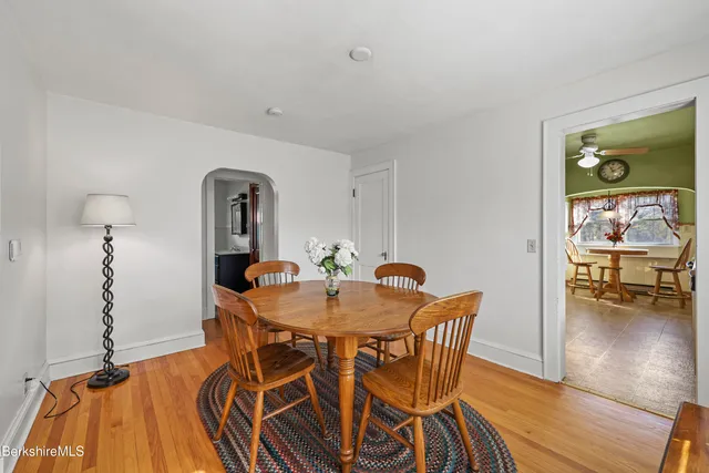 a dining room with furniture and wooden floor