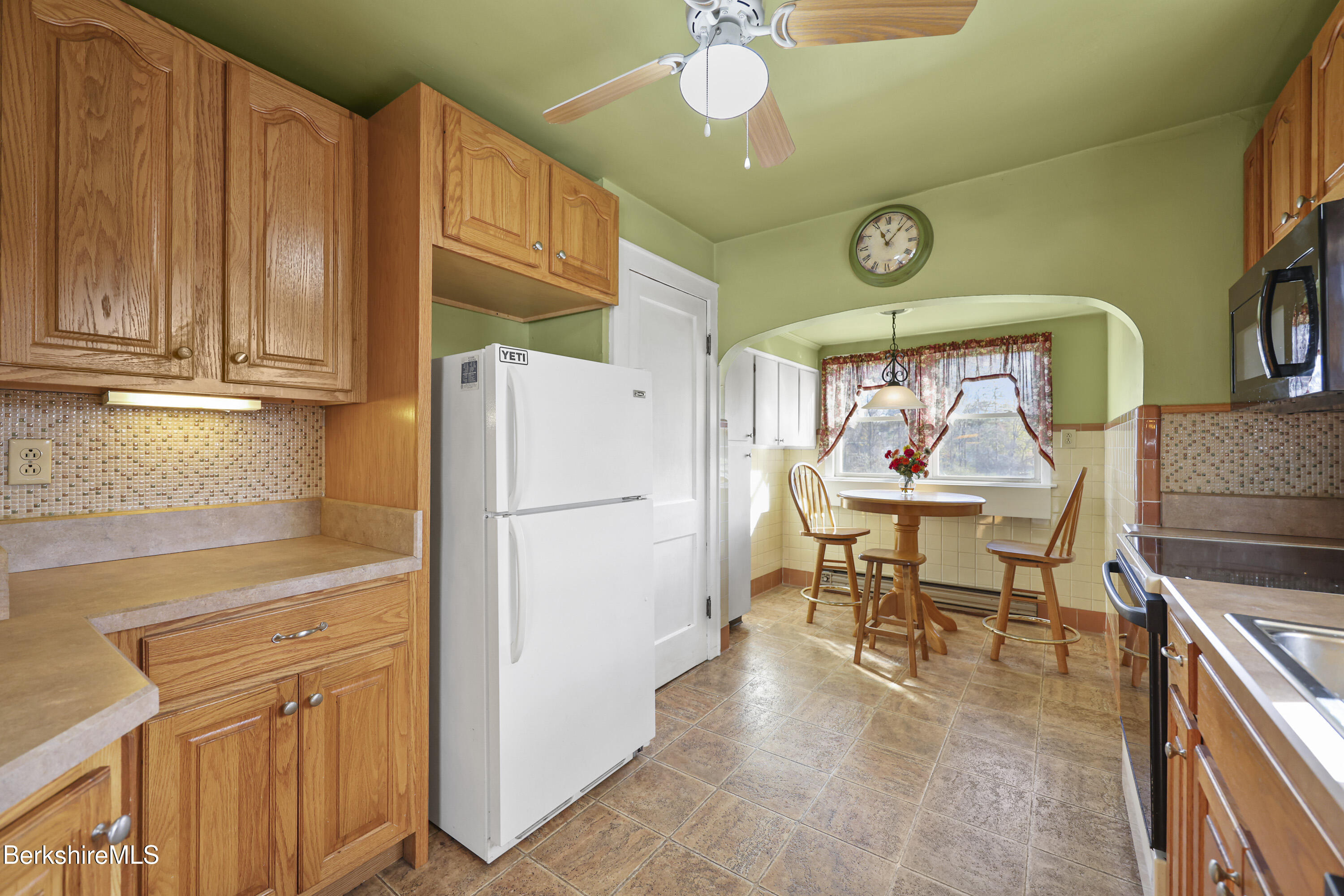 56 Tower Road Dalton, MA 01226 - Photo 8 of 24 a kitchen with stainless steel appliances granite countertop a refrigerator a sink dishwasher a dining table and chairs with wooden floor