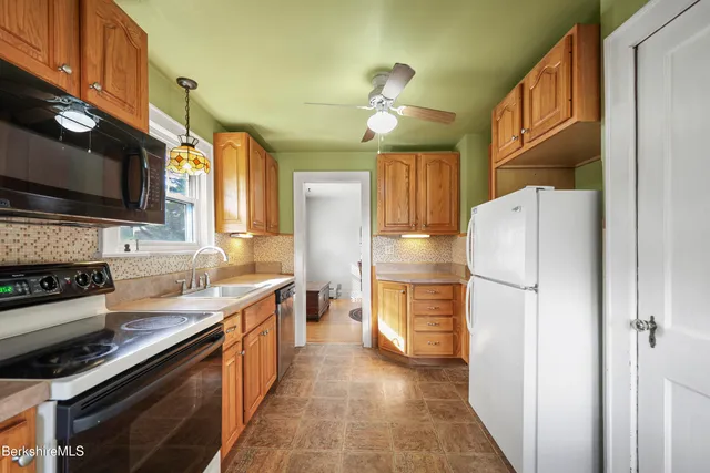 a kitchen with a refrigerator a stove and a microwave