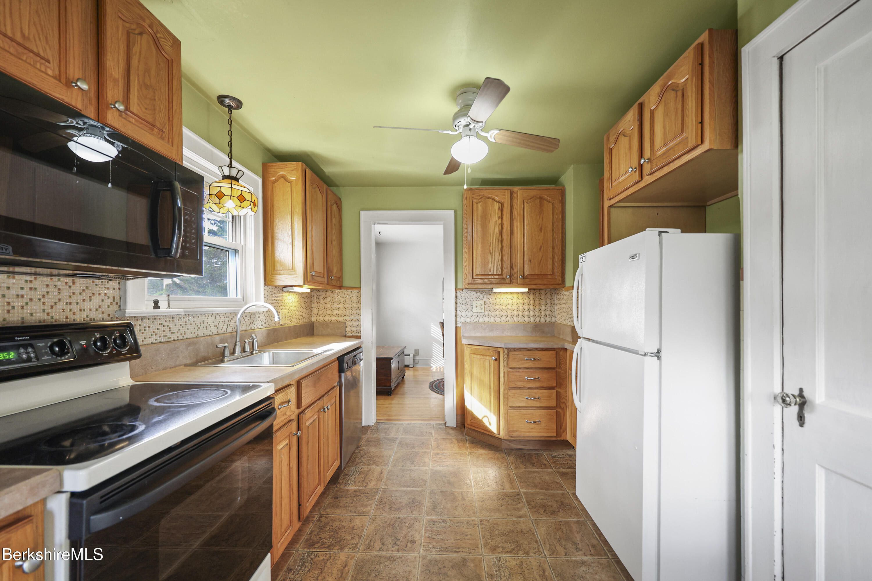 56 Tower Road Dalton, MA 01226 - Photo 10 of 24 a kitchen with a refrigerator a stove and a microwave