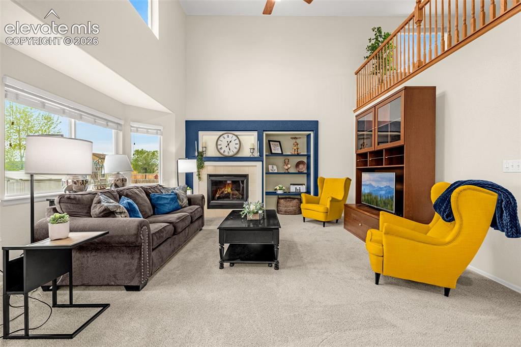 9127 Oakmont Road Peyton, CO 80831 - Photo 11 of 49 a living room with furniture and a fireplace