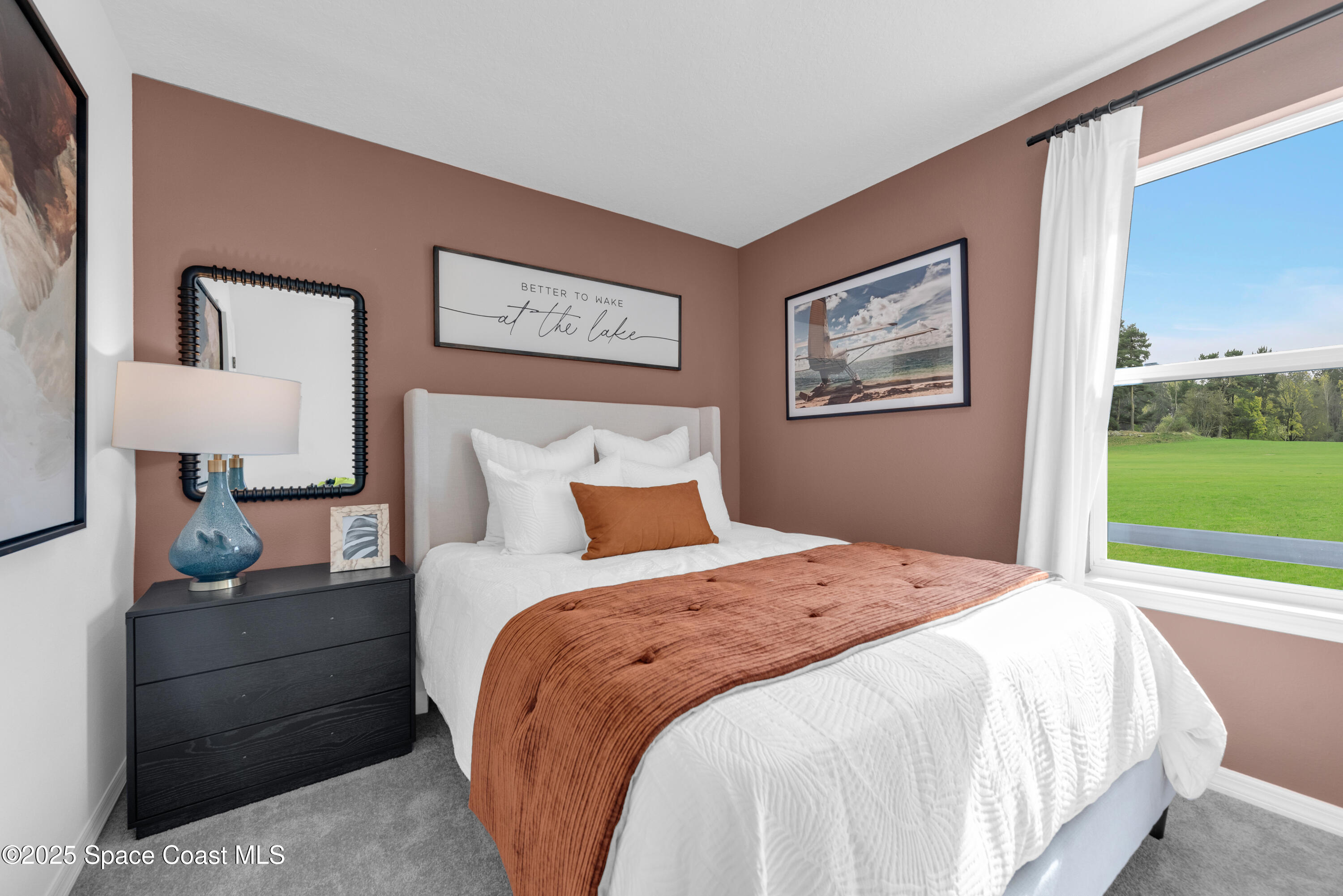 615 Poller Way Cocoa, FL 32927 - Photo 25 of 29 a spacious bedroom with a bed and a window