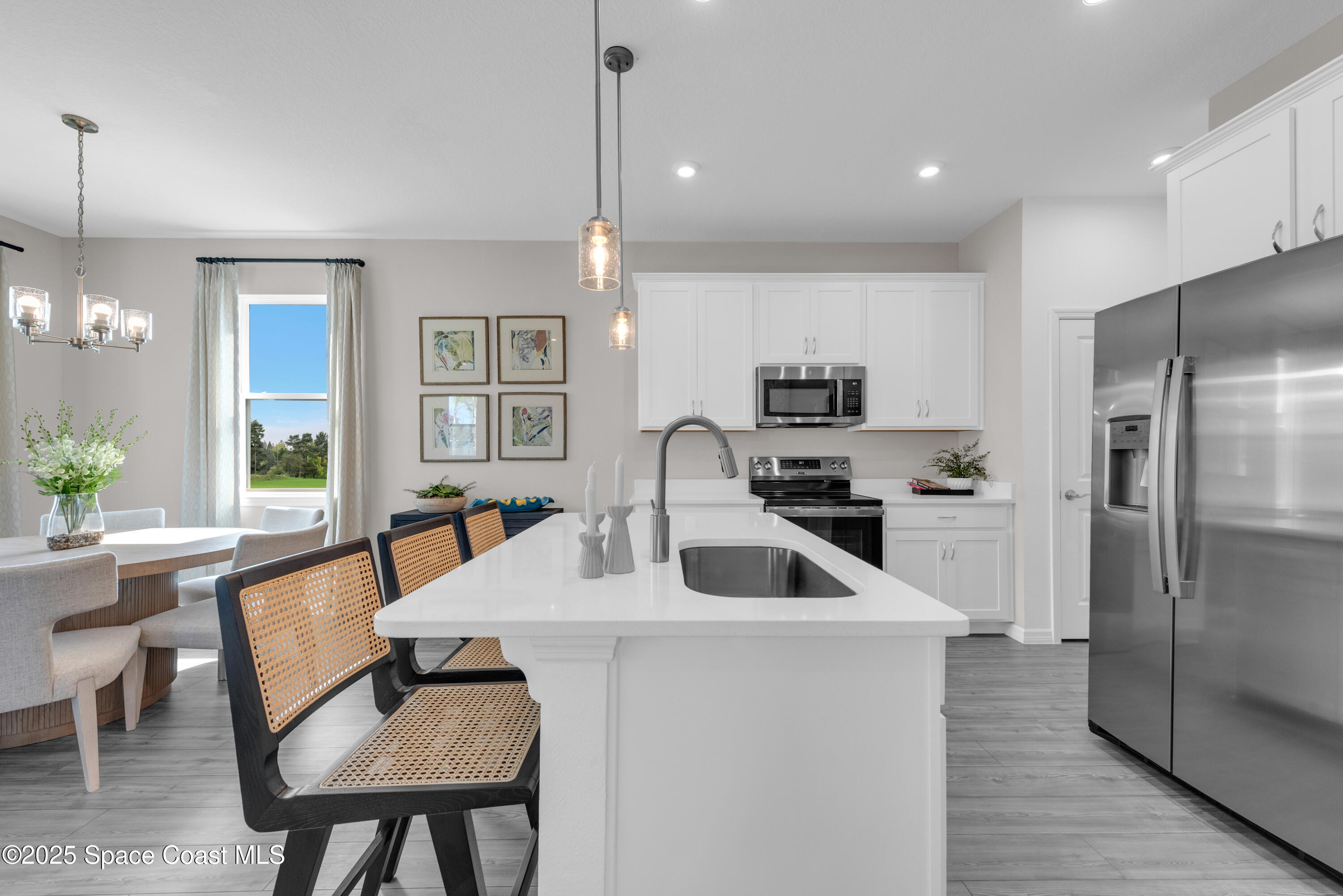 615 Poller Way Cocoa, FL 32927 - Photo 7 of 29 a kitchen with a table chairs refrigerator and microwave
