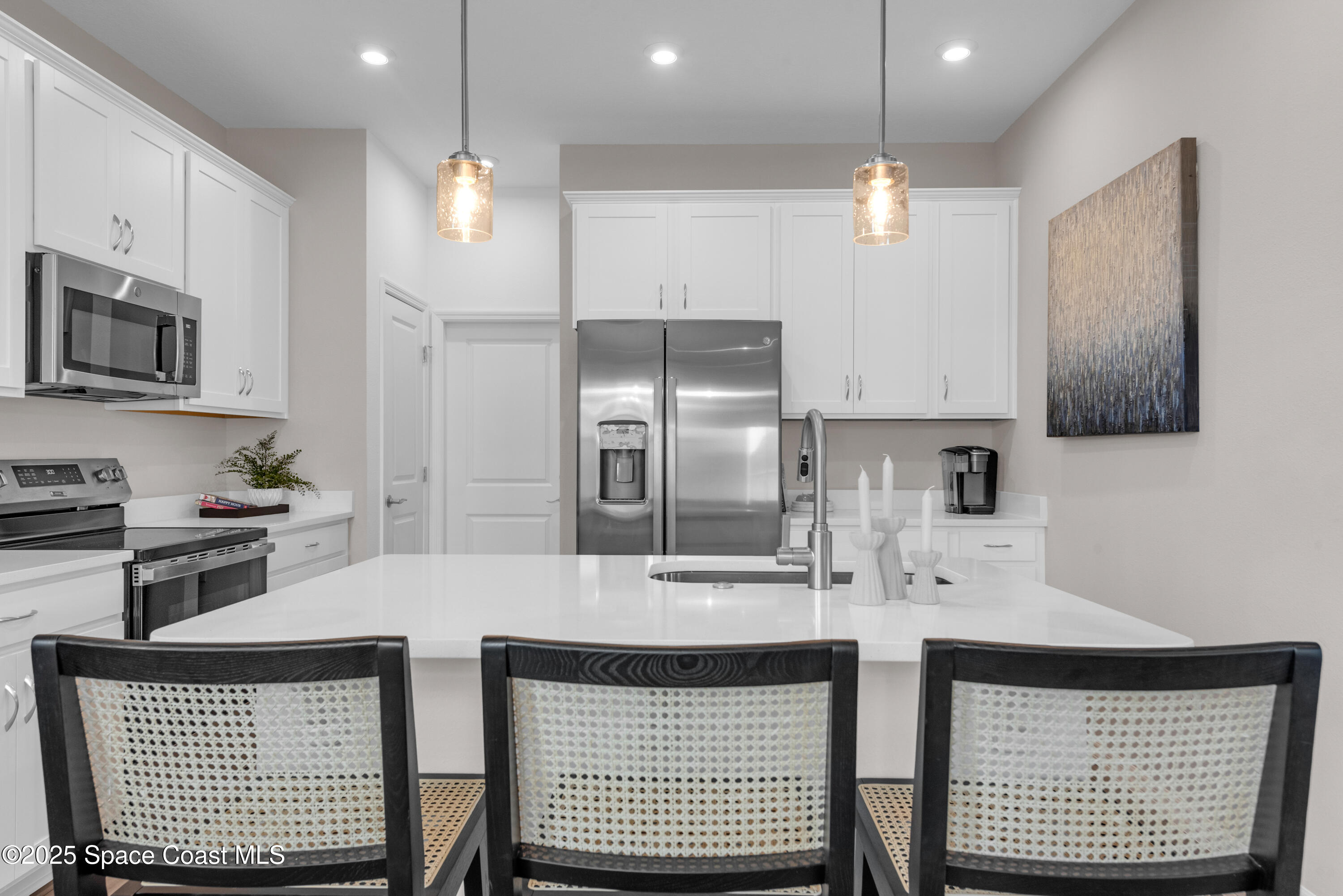 615 Poller Way Cocoa, FL 32927 - Photo 9 of 29 a kitchen with a sink stainless steel appliances and cabinets