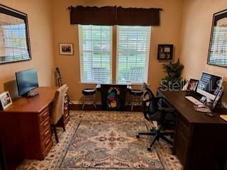 7971 Southwest 80th Lane Gainesville, FL 32608 - Photo 11 of 22 a bedroom with a workspace