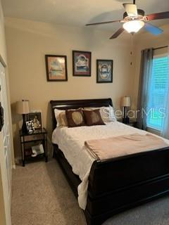 7971 Southwest 80th Lane Gainesville, FL 32608 - Photo 13 of 22 a bedroom with a bed and a chandelier