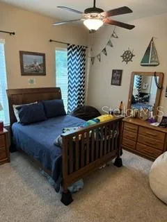 a bedroom with furniture and a window