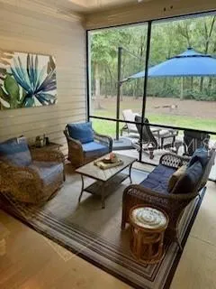 a living room with furniture and a floor to ceiling window