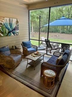 7971 Southwest 80th Lane Gainesville, FL 32608 - Photo 21 of 22 a living room with furniture and a floor to ceiling window