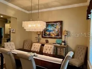 a living room with furniture and a wall painting