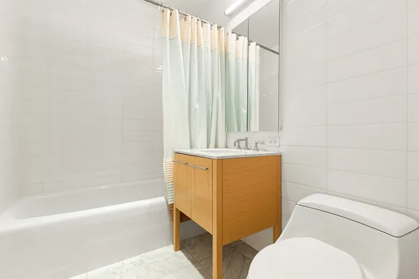 a bathroom with a sink a toilet and bathtub