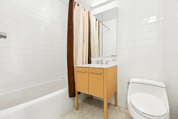 a bathroom with a sink a toilet and bathtub