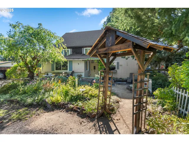 a view of a house with wooden fence