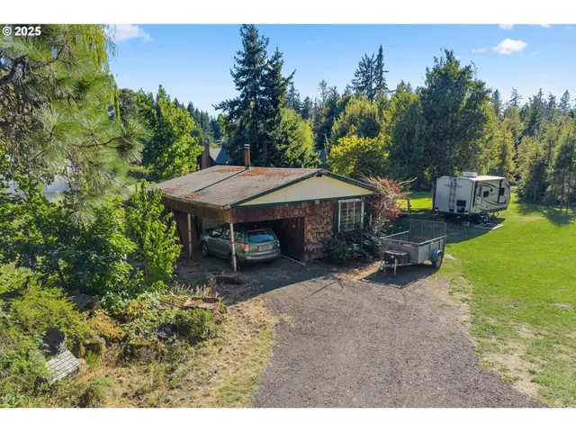 a view of a house with backyard porch and sitting area
