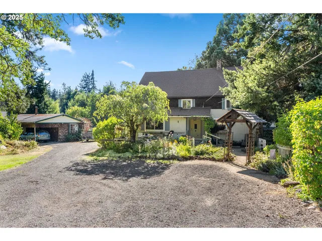 a view of a house with a yard and sitting area