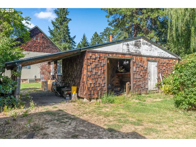 a view of a house with a yard and sitting area