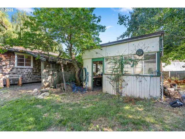 a backyard of a house with table and chairs