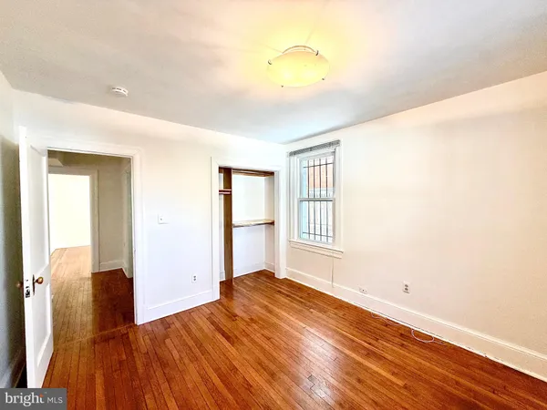 a kitchen with a stove a counter space and wooden floor